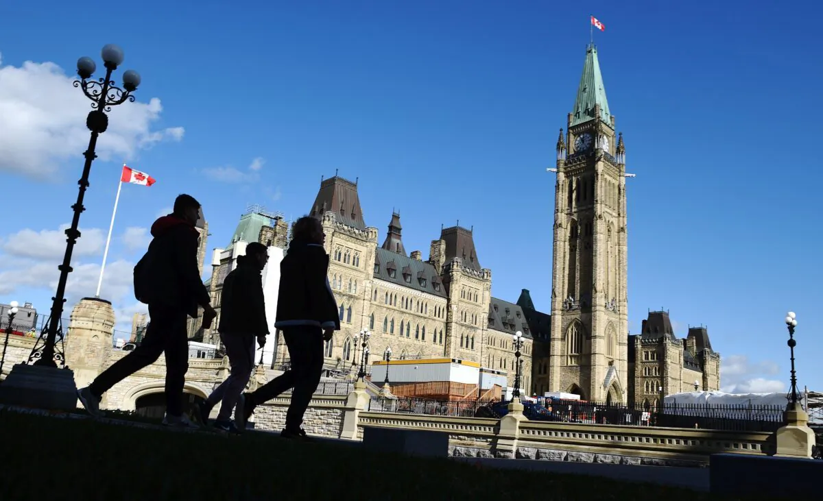 People walk near Parliament Hill on Oct. 23, 2019. (The Canadian Press/Sean Kilpatrick)