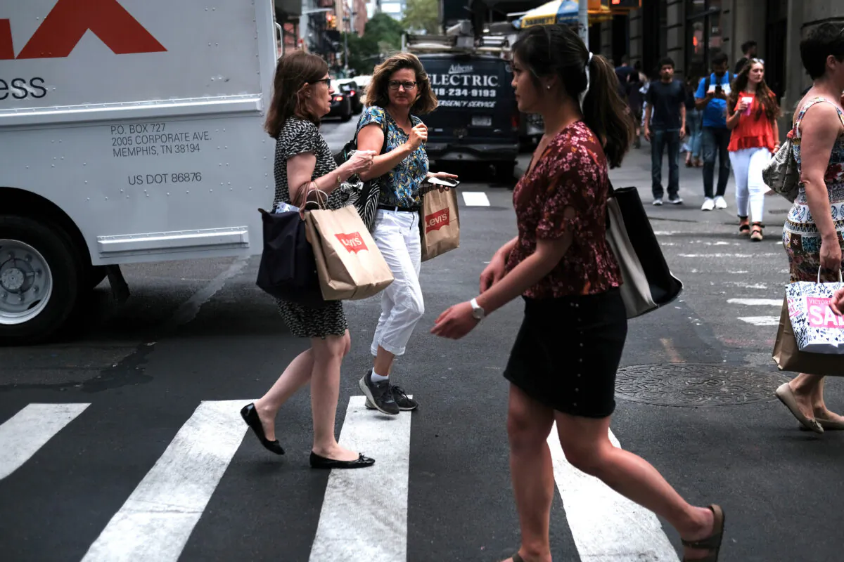 People walk along a shopping street in lower Manhattan in New York City on July 5, 2019. (Spencer Platt/Getty Images)