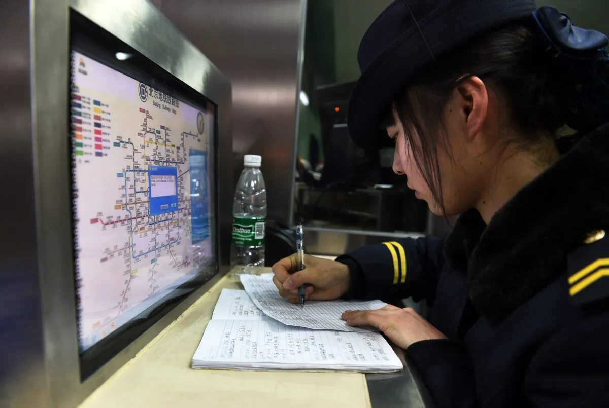 An attendant works in front of a subway map at a subway station in Beijing on Dec. 29, 2014. (GREG BAKER/AFP via Getty Images)