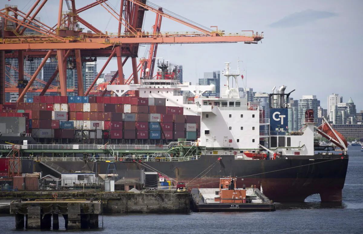 A cargo ship is loaded in Vancouver, B.C., in a file photo. (THE CANADIAN PRESS/Jonathan Hayward)