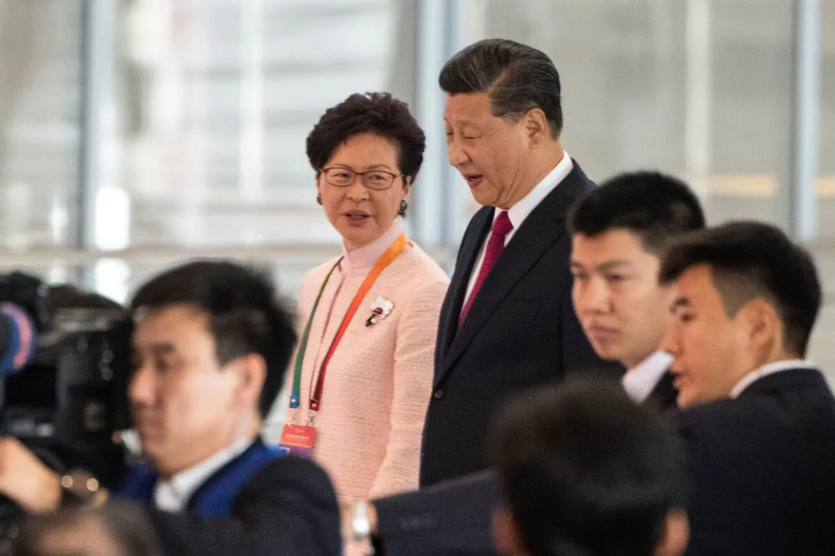 Hong Kong's Chief Executive Carrie Lam and Chinese leader Xi Jinping arrive at the opening ceremony of the Hong Kong-Zhuhai-Macau Bridge at the Zhuhai Port terminal on October 23, 2018. (FRED DUFOUR/AFP via Getty Images)