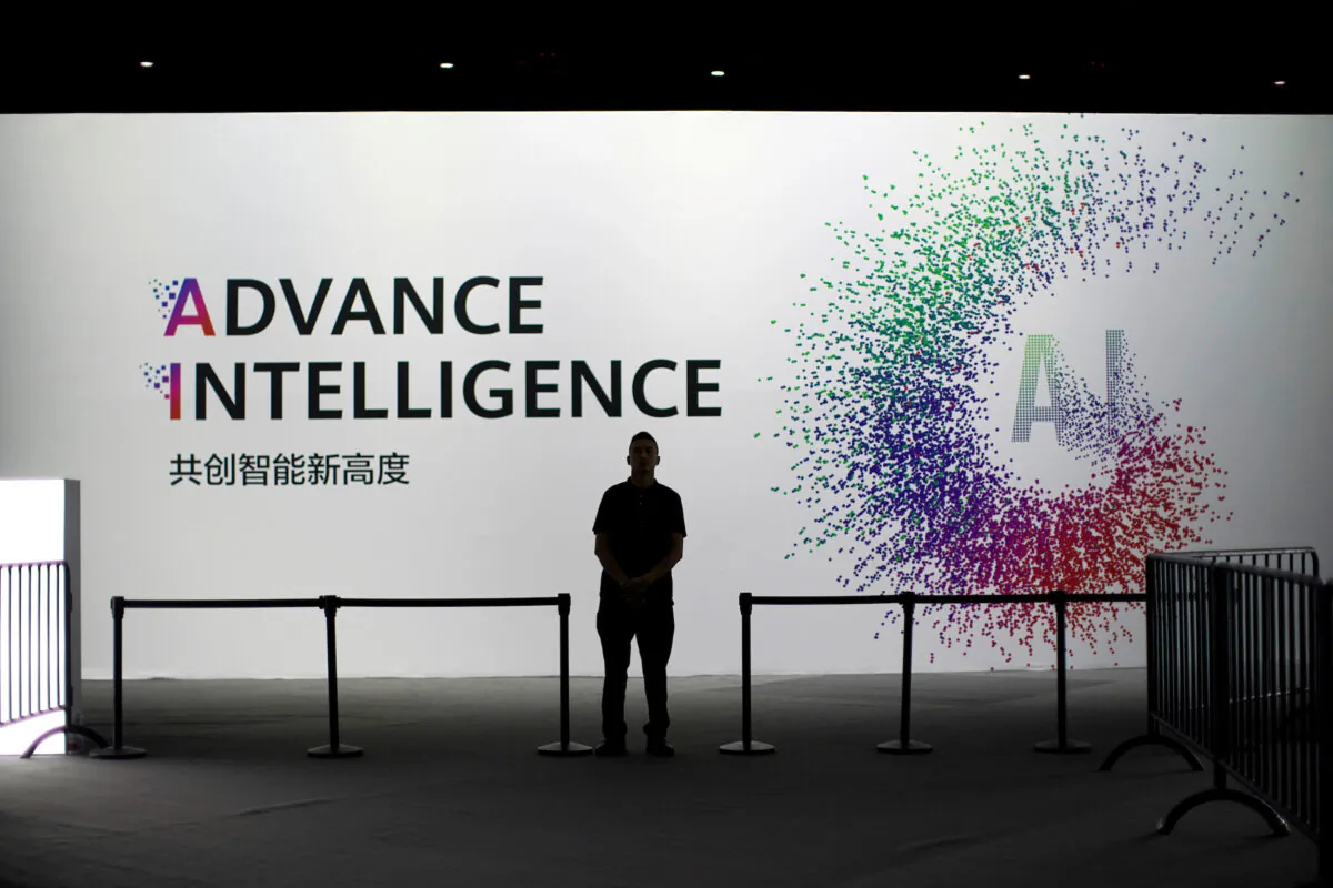 A security officer keeps watch in front of an artificial intelligence sign at the annual Huawei Connect event in Shanghai on Sept. 18, 2019. (Aly Song/Reuters)