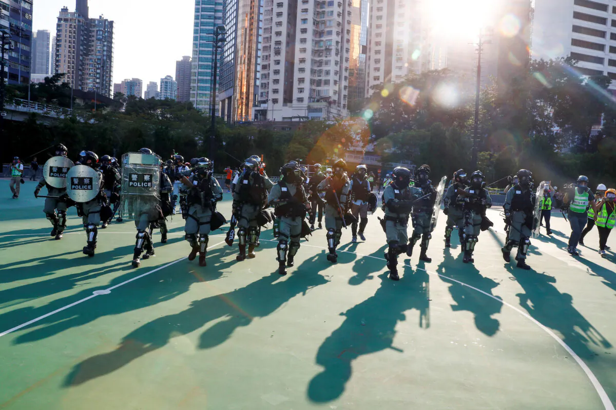 Police in riot gear enter Victoria Park as they disperse protesters in Hong Kong on Nov. 2, 2019. (Thomas Peter/Reuters)