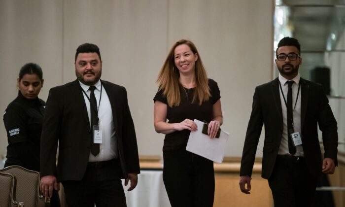 Writer Meghan Murphy is flanked by security before speaking at a panel discussion on gender identity in Vancouver on Nov. 2, 2019. (THE CANADIAN PRESS/Darryl Dyck)