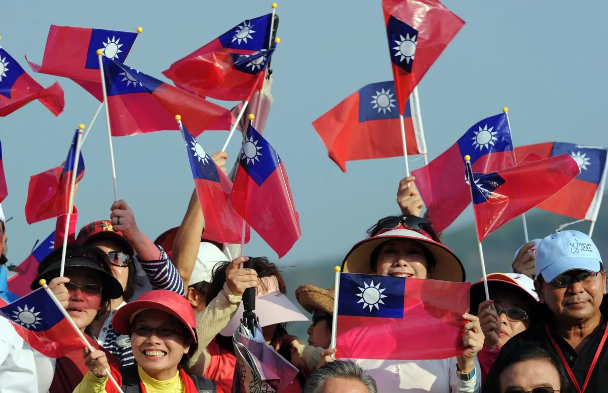 Taiwanes golf fans wave their national flag during the trophy ceremony after the final round in the LPGA Thailand golf tournament at the Pattaya resort on February 20, 2011. (PORNCHAI KITTIWONGSAKUL/AFP via Getty Images)