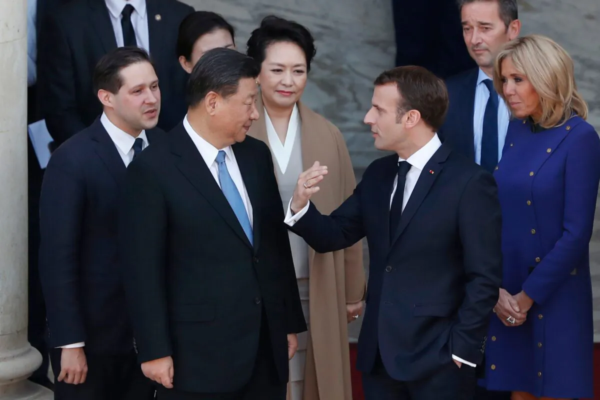 French President Emmanuel Macron and his wife Brigitte Macron (R) speak with Chinese leader Xi Jinping and his wife Peng Liyuan (C) following a meeting at the Elysee Palace in Paris on March 26, 2019. (THIBAULT CAMUS/AFP via Getty Images)