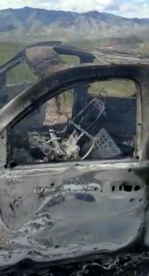 The burnt wreckage of a vehicle is seen in Bavispe