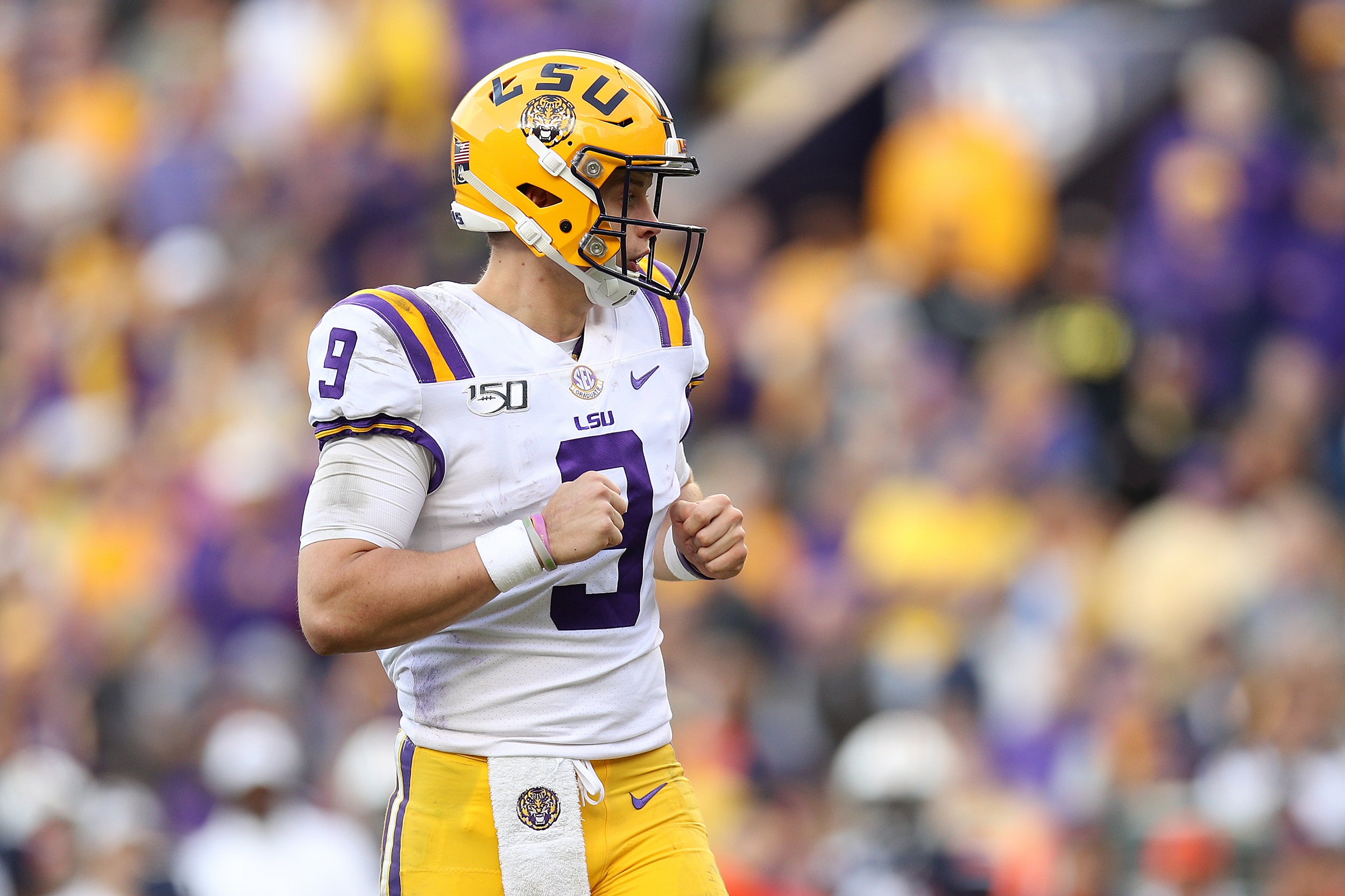 Joe Burrow LSU Tigers Unsigned White Jersey Warming Up At Night Under The  Spotlights Photograph