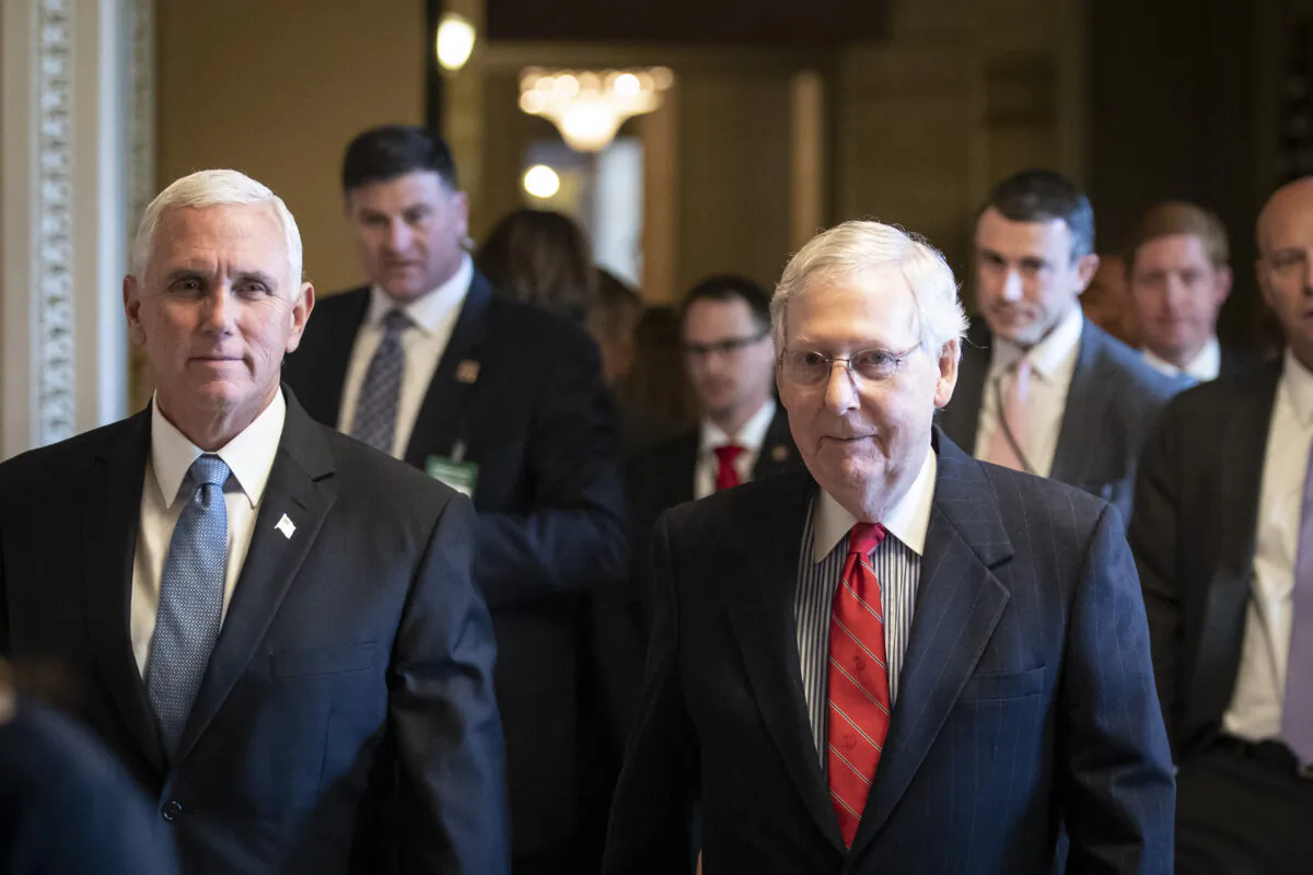 Vice President Mike Pence, left, and Senate Majority Leader Mitch McConnell (R-Ky.) walk to the Republican policy luncheon at the U.S. Capitol in Washington on Nov. 5, 2019. (Drew Angerer/Getty Images)