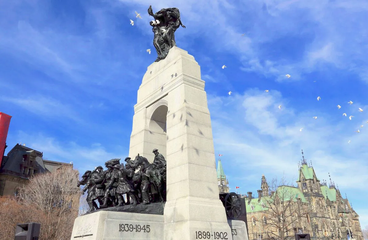 White doves fly over the National War Memorial during a ceremony commemorating the 100th Anniversary of Vimy Ridge, in Ottawa on April 9, 2017. (The Canadian Press/Fred Chartrand)