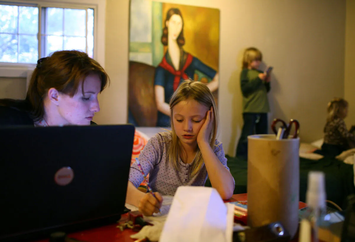 In this file photo, a homeless family stays in a motel after being evicted from their rented house when the father lost his job, in West Sacramento, Calif., on March 5, 2009. (Justin Sullivan/Getty Images)