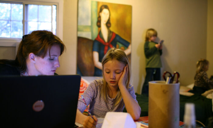 In this file photo, a homeless family stays in a motel after being evicted from their rented house when the father lost his job, in West Sacramento, Calif., on March 5, 2009. (Justin Sullivan/Getty Images)