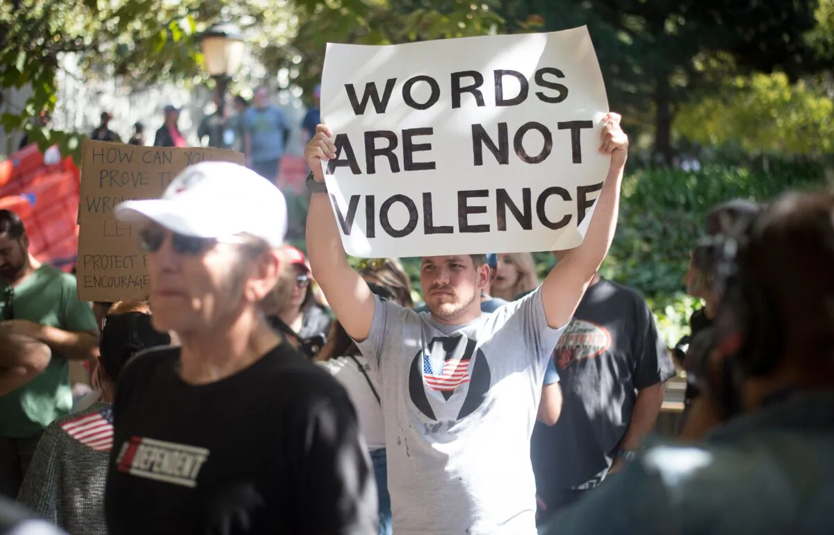 Protesters hold up signs at a university campus in California on Sept. 24, 2017. (Josh Edelson/AFP via Getty Images)