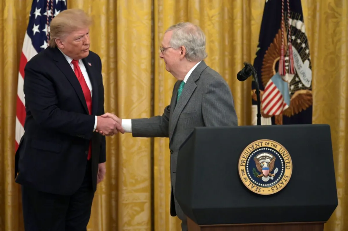 President Donald Trump and Senate Majority Leader Mitch McConnell (R) shake hands at the White House on Nov. 6, 2019. (Jim Watson/AFP via Getty Images)