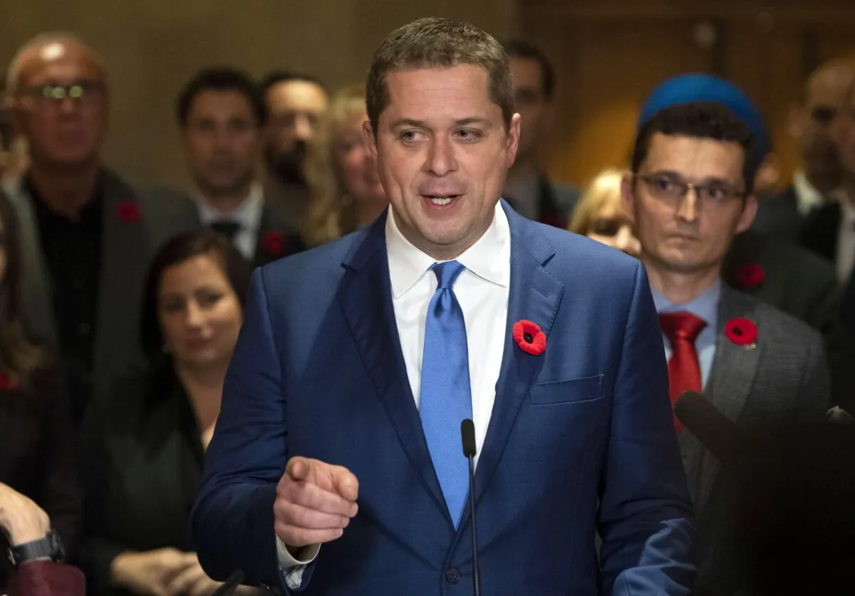 Conservative leader Andrew Scheer is surrounded by members of his caucus as he speaks to reporters following a caucus meeting on Parliament Hill in Ottawa on Nov. 6, 2019. (THE CANADIAN PRESS/Justin Tang)