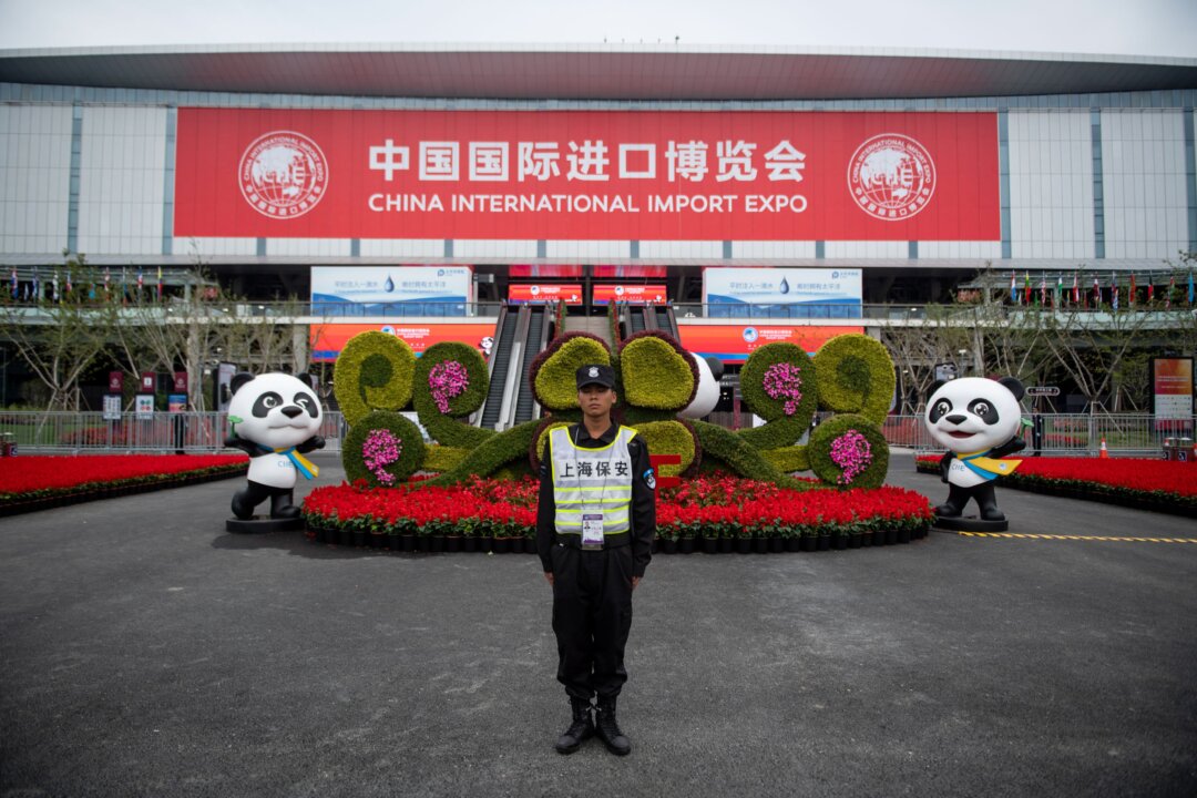 A security guard stands at the entrance to the first China International Import Expo (CIIE) in Shanghai on Nov. 5, 2019. Chinese leader Xi Jinping vowed on Nov. 5 to open access to China's economy, while delivering a veiled rebuke to the Trump administration, as he kicked off an import fair amid growing foreign accusations that his government was backtracking on reform pledges. (Johannes Eisele/AFP via Getty Images)