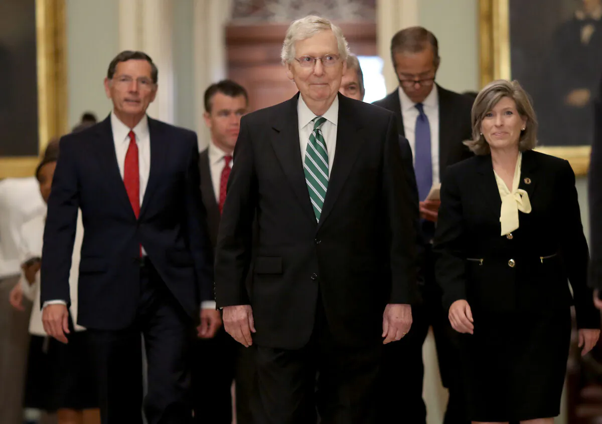 Senate Majority Leader Mitch McConell (R-Ky.) (C) walks to a press conference with fellow Republicans following the weekly Republican policy luncheon in Washington on July 30, 2019. (Win McNamee/Getty Images)