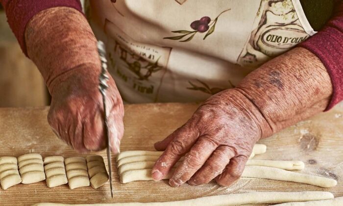 Maria cuts ropes of dough into three-finger-long pieces for her raschiatelli. (Emma Lee)