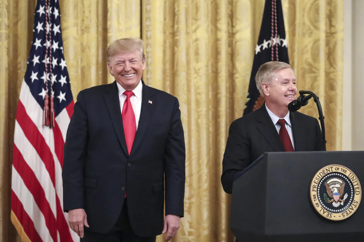 President Donald Trump (L) looks on as Sen. Lindsey Graham (R-S.C.) speaks during an event about judicial confirmations in the East Room of the White House on Nov. 6, 2019. (Drew Angerer/Getty Images)