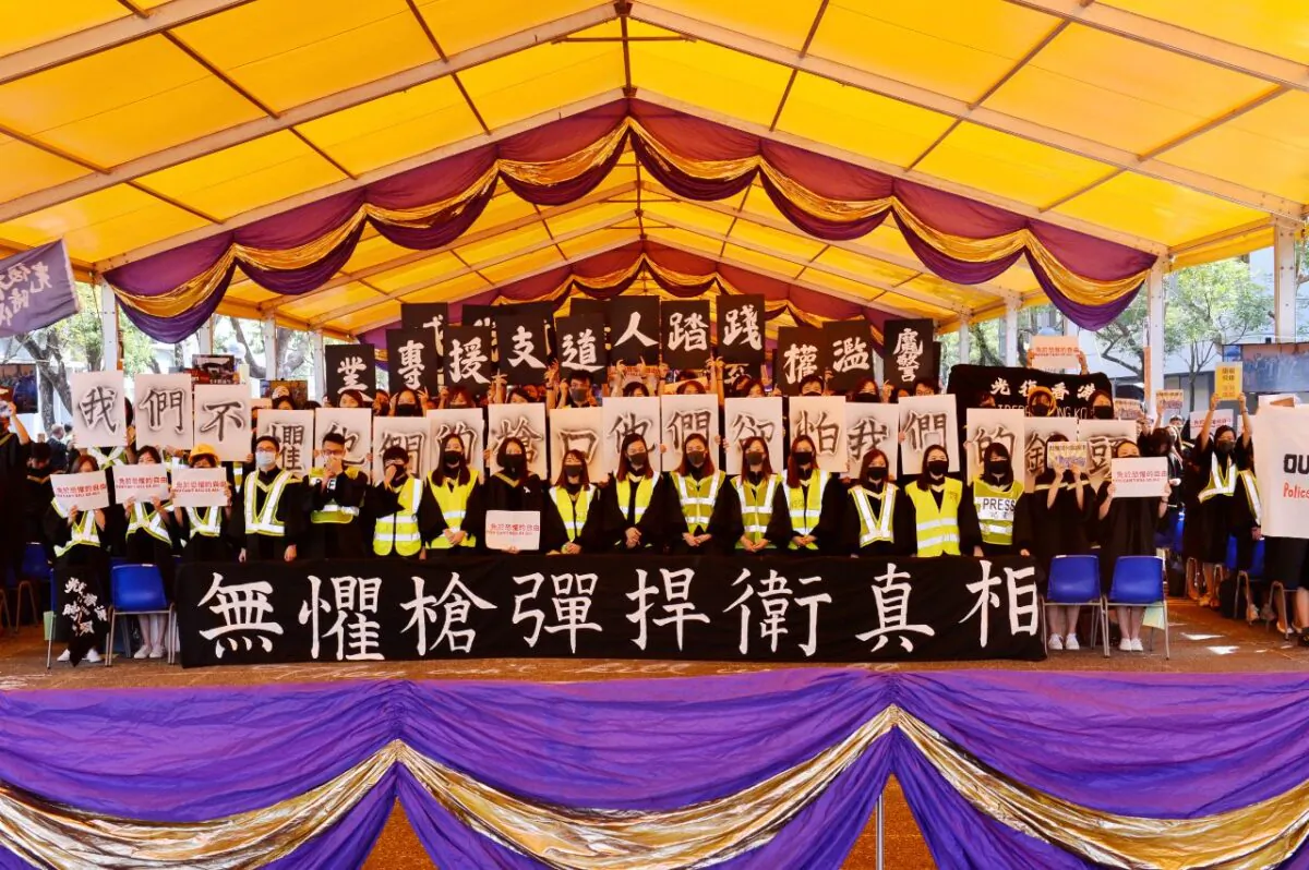 Graduates wearing masks hold an anti-government rally after their graduation ceremony at the Chinese University of Hong Kong in Hong Kong, China on Nov. 7, 2019. (Sung Pi Lung/The Epoch Times)