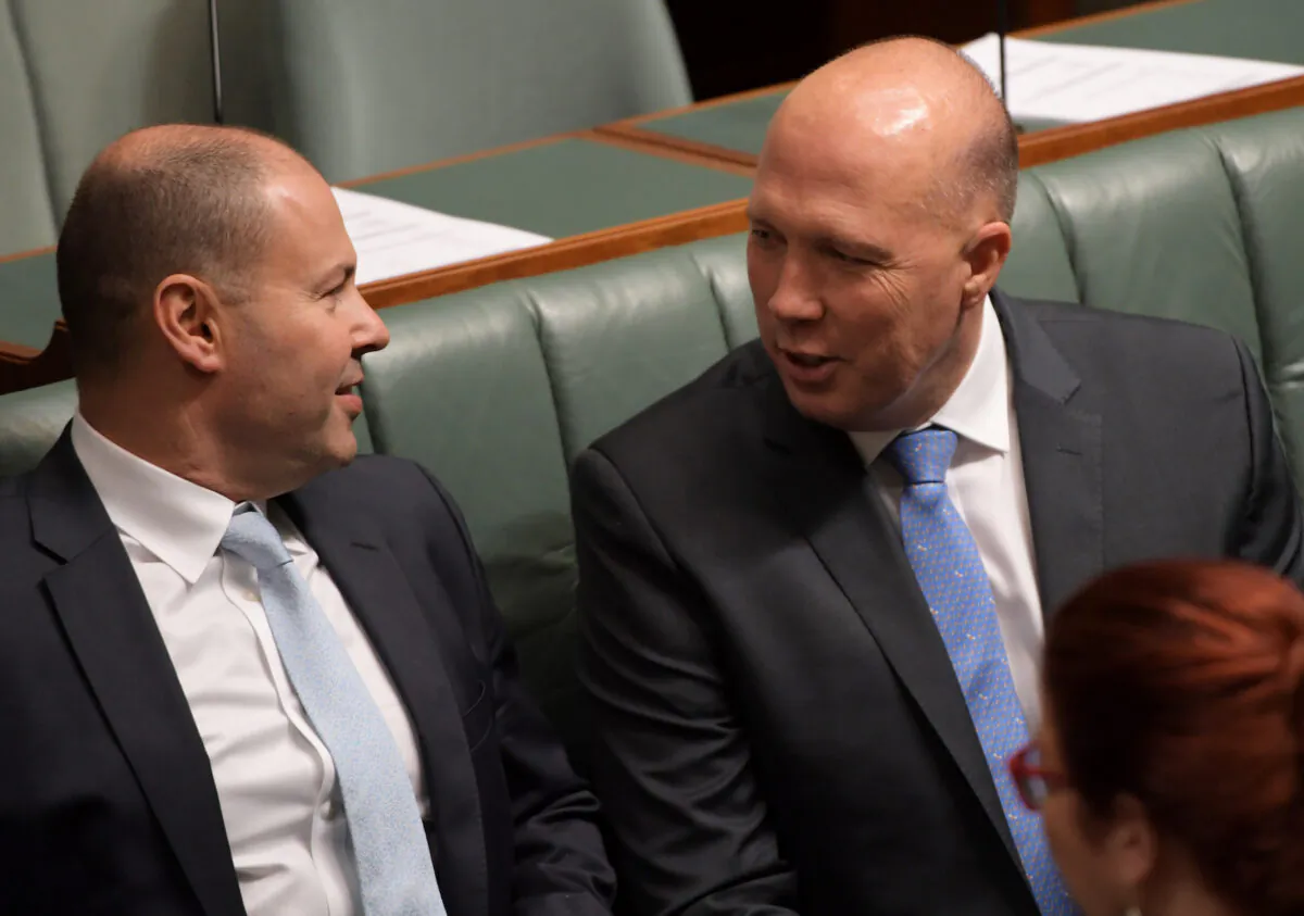 Treasurer Josh Frydenberg (L) and Home Affairs Minister Peter Dutton talk during a vote to suspend standing orders in the House of Representatives at Parliament House in Canberra, Australia, on Feb. 21, 2019. (Tracey Nearmy/Getty Images)