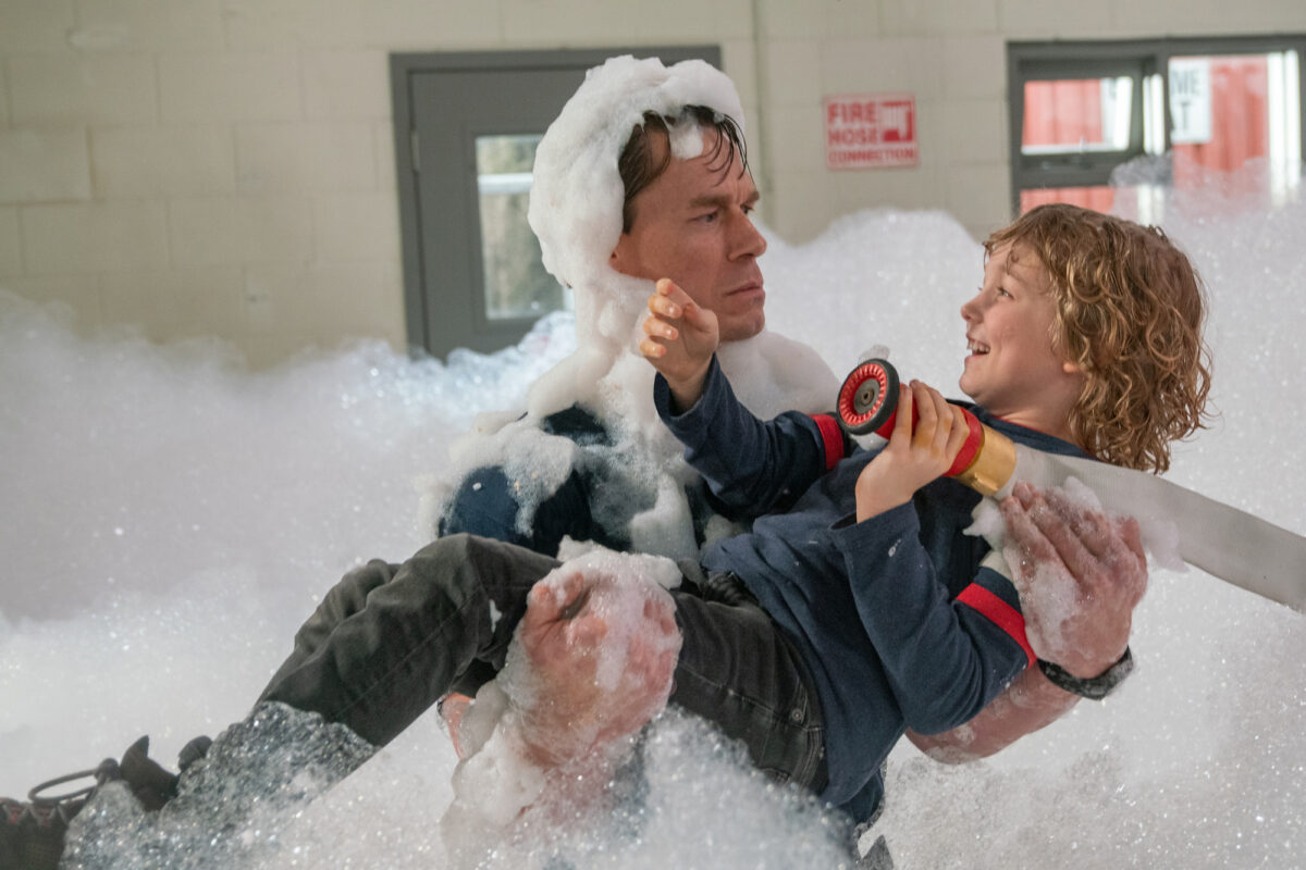 Fireman and boy in bubble-filled firehouse
