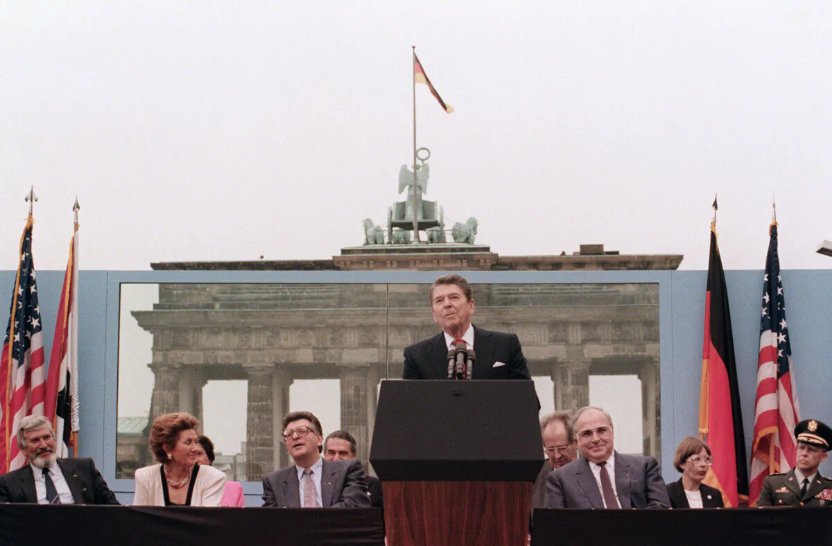 U.S. President Ronald Reagan, commemorating the 750th anniversary of Berlin, addresses the people of West Berlin at the base of the Brandenburg Gate, near the Berlin wall, on June 12, 1987. Reagan famously said, “Mr. Gorbachev, tear down this wall.” (MIKE SARGENT/AFP via Getty Images)