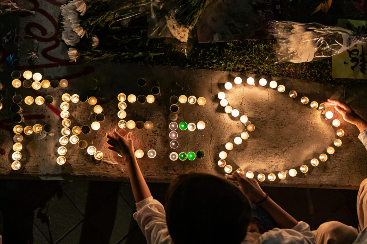 People light candles during a remembrance prayer in memory of university student Alex Chow in Hong Kong, on Nov. 9, 2019. (Anthony Kwan/Getty Images)