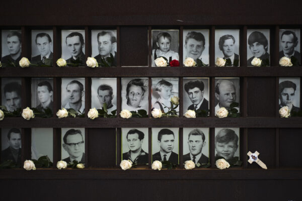 Flowers dropped in front of portraits from people died at the Berlin wall after commemorations celebrating the 30th anniversary of the fall of the Berlin Wall at the Wall memorial site at Bernauer Strasse in Berlin, Nov. 9, 2019. (Markus Schreiber/AP Photo)