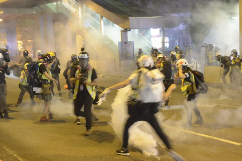 Police fire tear gas toward journalists in a shopping mall in Tsuen Wan, Hong Kong, on Nov. 10, 2019. (Gordon Yu/The Epoch Times) 