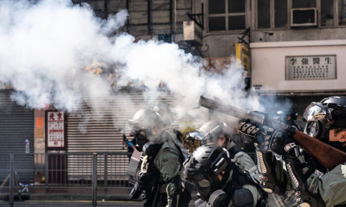 Riot police charge as they fire tear gas on a street to disperse protesters in Hong Kong on Nov.11, 2019. (Anthony Kwan/Getty Images)