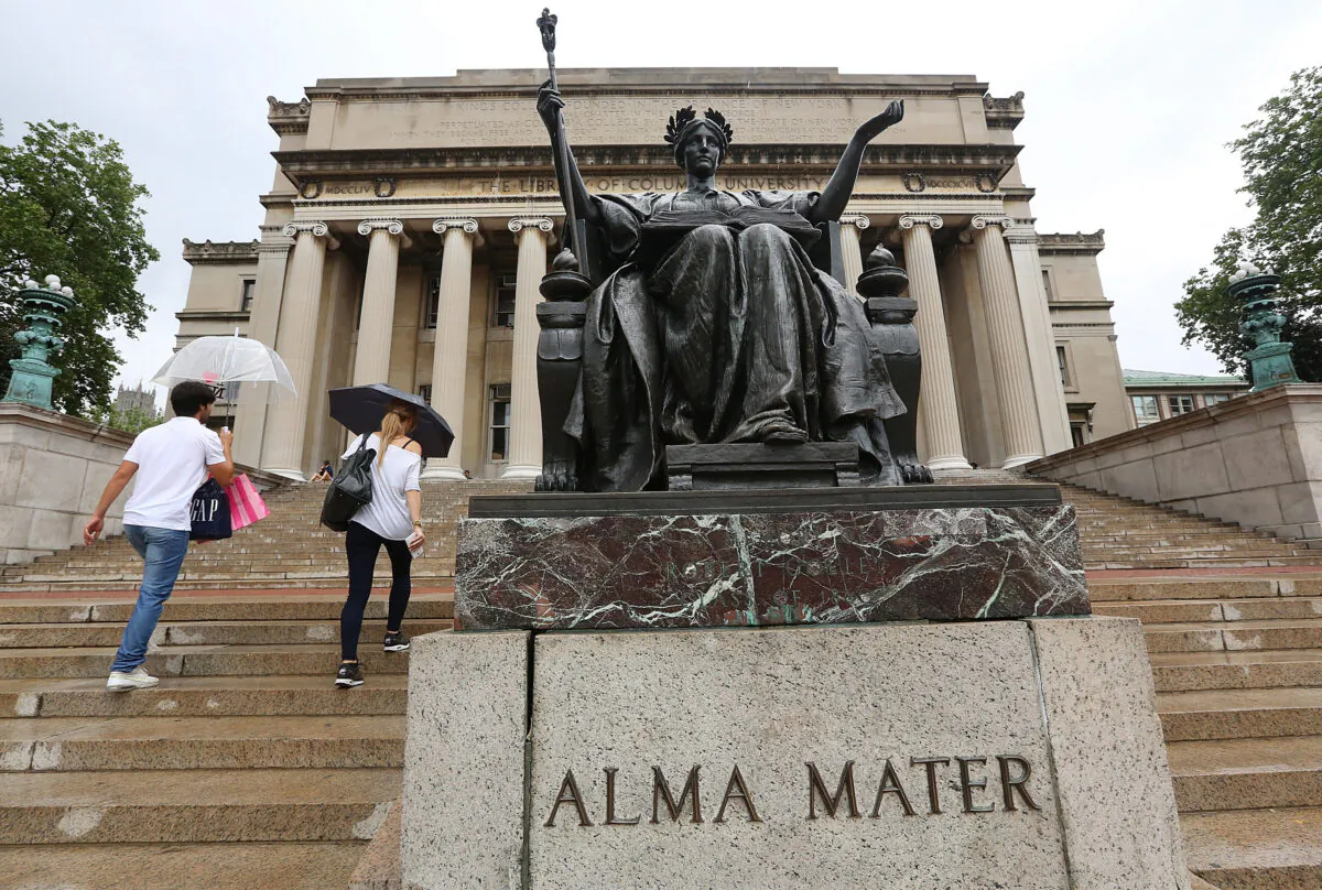 People walk past the Alma Mater statue on the Columbia University campus in New York on July 1, 2013. (Mario Tama/Getty Images)