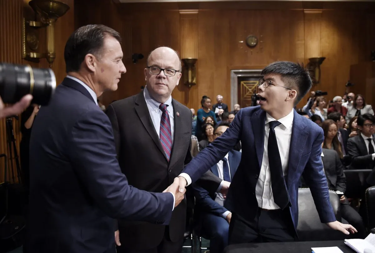 Activist Joshua Wong (R) meet with Rep. Tom Suozzi (D-N.Y.) and CECC Chairman Jim McGovern (D-Mass.) ahead of a hearing about the pro-democracy movement in Hong Kong, on Capitol Hill in Washington, on Sept. 17, 2019. (Olivier Douliery/AFP via Getty Images)