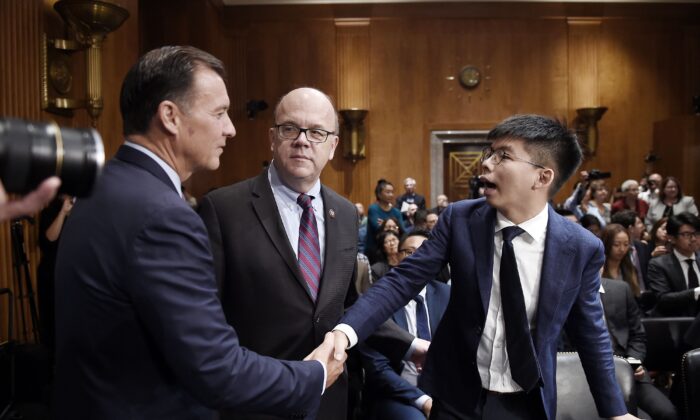 Activist Joshua Wong (R) meets with Rep. Tom Suozzi (D-N.Y.) and CECC Chairman Jim McGovern (D-Mass.) ahead of a hearing about the pro-democracy movement in Hong Kong, on Capitol Hill  on Sept. 17, 2019. (Olivier Douliery/AFP via Getty Images)