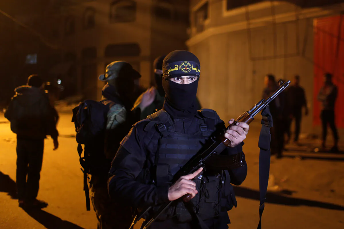A Palestinian Islamic Jihad extremist stands guard at the scene of an Israeli strike that killed the group's field commander Baha Abu Al-Atta in Gaza City on Nov. 12, 2019. (Mohammed Salem/Reuters)