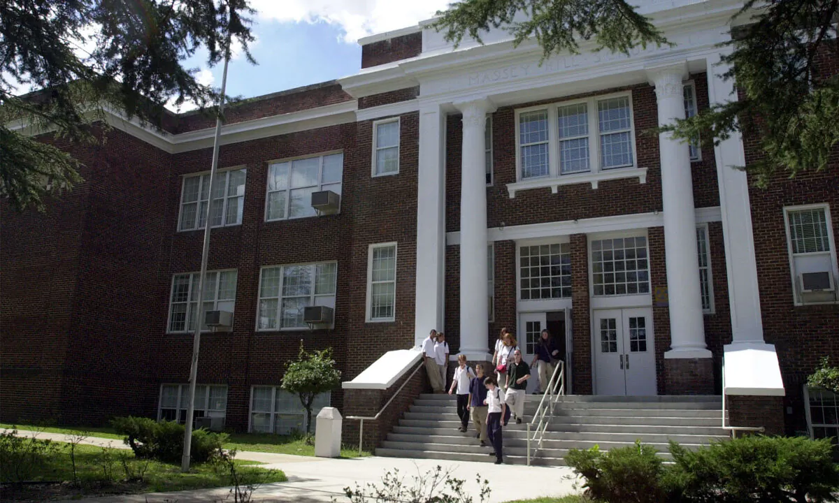 Students exit Massey Hill Classical high school in Fayetteville, NC, on Sept. 13, 2000. The school, while fully part of the public school system, has a "classical" curriculum based on fundamental arts and sciences, and has no sports teams. Students are required to wear uniforms. The three-year-old school is part of an educational experiment in North Carolina-using some of the features of private schools in the public school system. Chris Hondros/Newsmakers