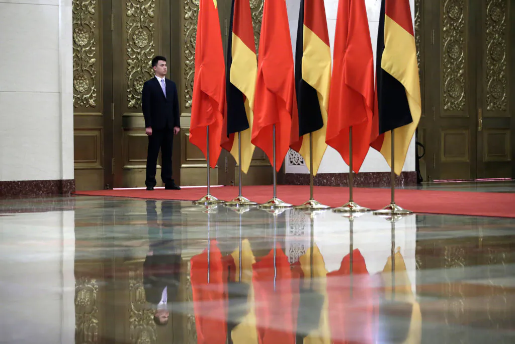 A security personnel stands guard next to Chinese and German flags during a meeting between China's President Xi Jinping and German Chancellor Angela Merkel at the Great Hall of the People in Beijing on May 24, 2018. (Jason Lee/AFP via Getty Images)