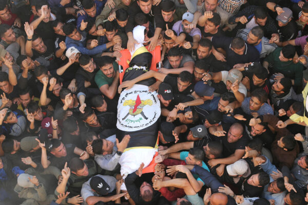 Mourners carry the body of Palestinian Islamic Jihad field commander Baha Abu Al-Atta during his funeral in Gaza City