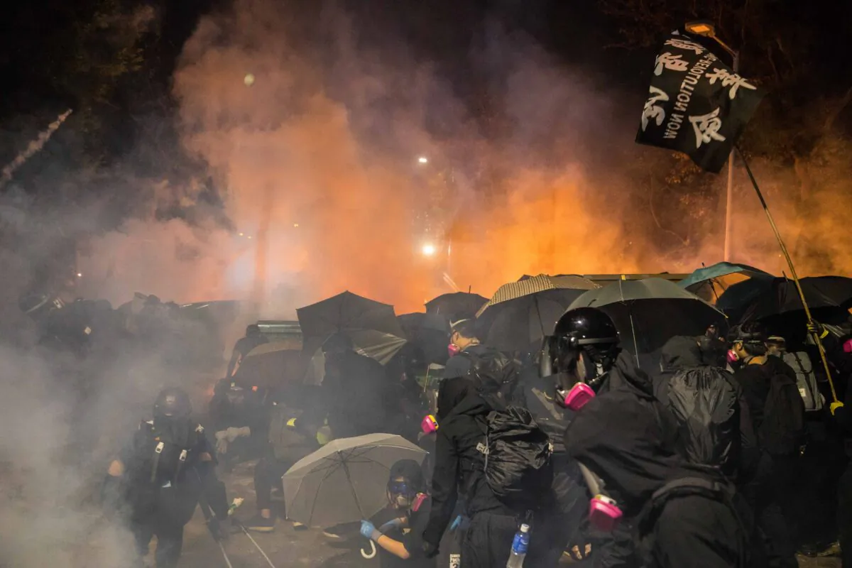 Protesters react after police fired tear gas at the Chinese University of Hong Kong (CUHK), in Hong Kong on Nov. 12, 2019. (Dale de la Rey/AFP via Getty Images)