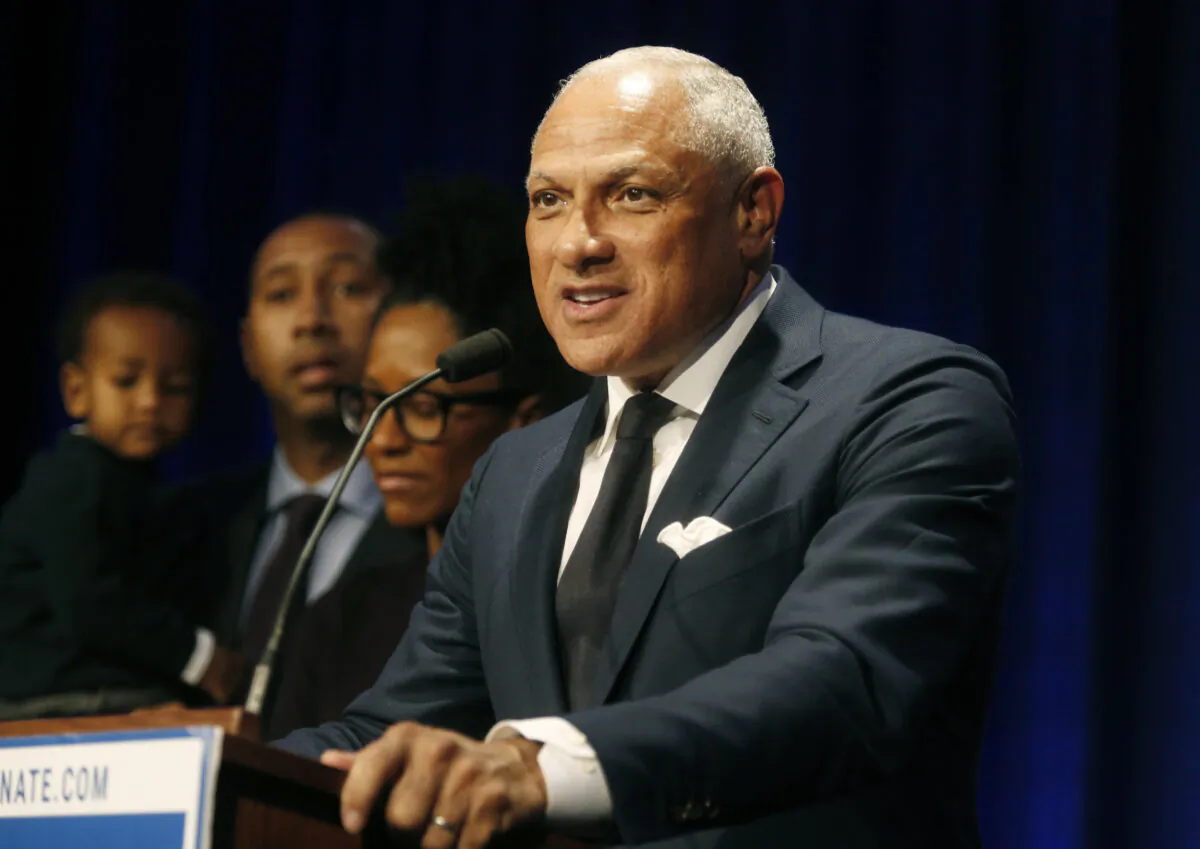 Mississippi Democrat Mike Espy stands with family members as he talks to supporters in a crowded auditorium at the Mississippi Civil Rights Museum in Jackson, Mississippi on Nov. 27, 2018. (AP Photo/Charles A. Smith, File)