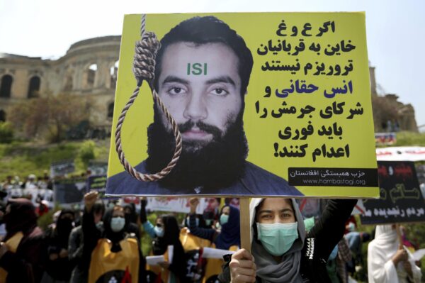 protester holds a poster with Persian