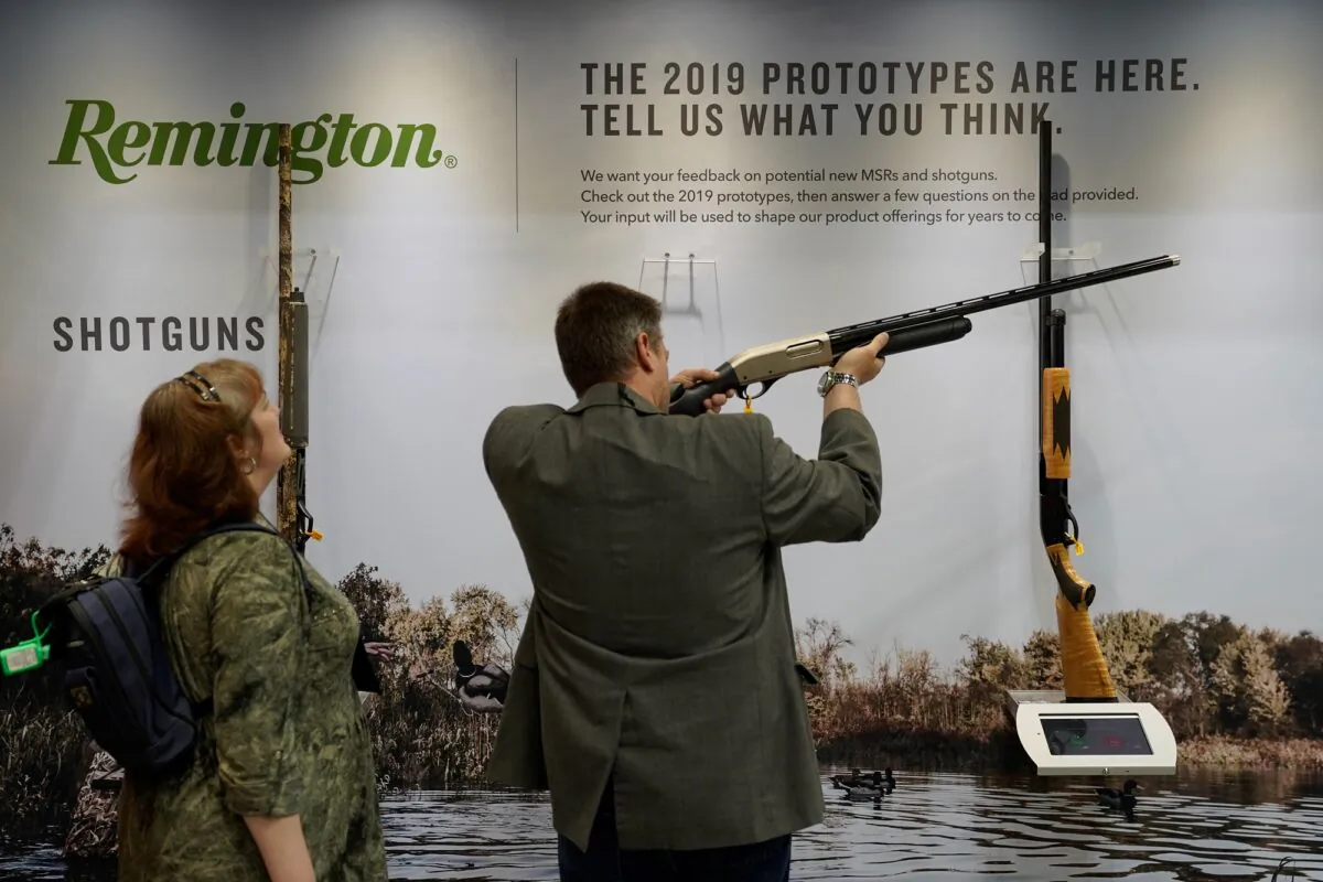 Attendees examine a Remington shotgun at the National Rifle Association's annual meeting, in Indianapolis, Indiana, on April 28, 2019. (Bryan Woolston/Reuters)