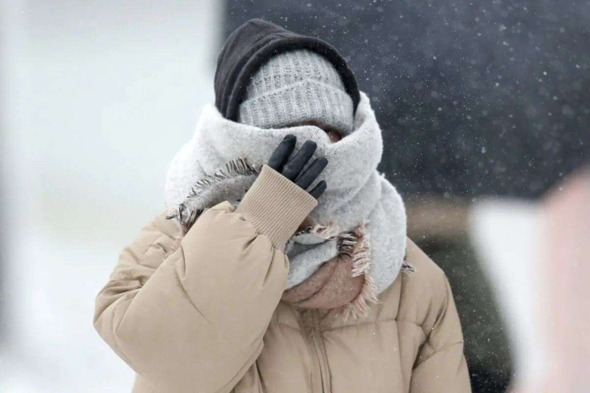 A woman walking the half mile from the Chicago Aquarium to the Adler Planetarium braces in a stiff wind and blowing snow off Lake Michigan on Nov. 11, 2019, in Chicago. (Charles Rex Arbogast/AP Photo)