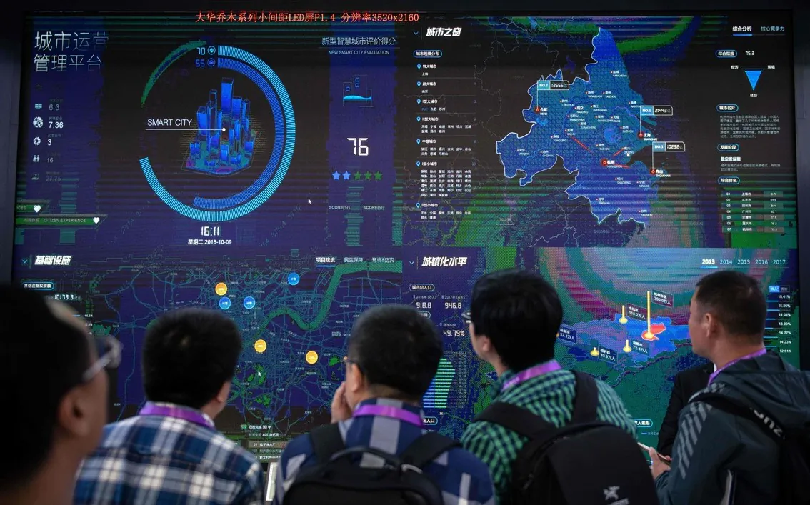 Visitors look at an AI (Artificial Inteligence) security software program on a screen at the 14th China International Exhibition on Public Safety and Security at the China International Exhibition Center in Beijing on Oct. 24, 2018. (NICOLAS ASFOURI/AFP via Getty Images)