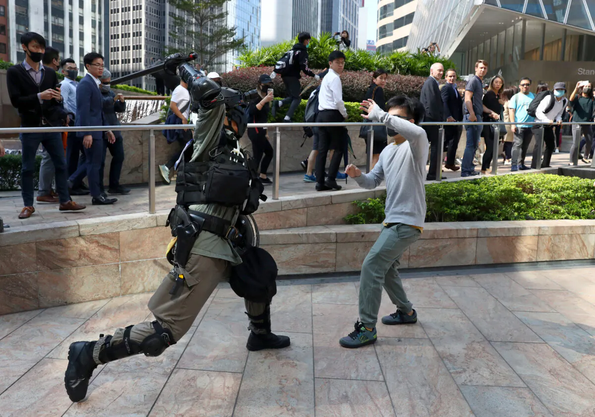 A riot police officer clashes with an anti-government protester during a demonstration at the Central District in Hong Kong on Nov.13, 2019. (Athit Perawongmetha/Reuters)