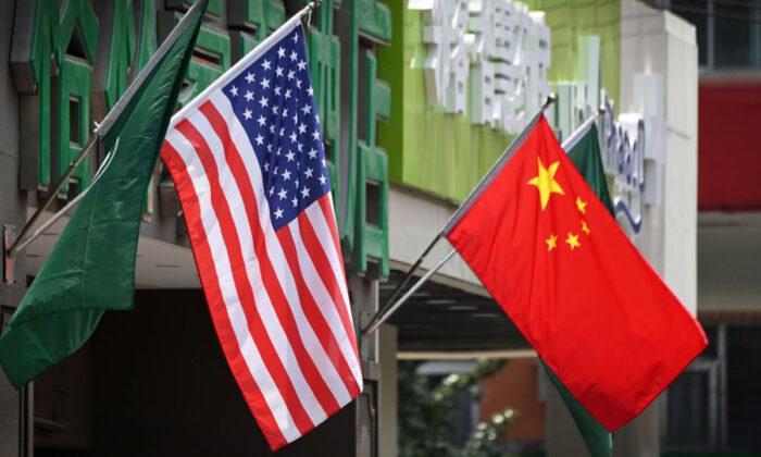 The U.S. and Chinese flags are displayed outside a hotel in Beijing on May 14, 2019. Experts say “authoritarian revisionist powers” in a Nov. 4 report on the Indo-Pacific by the State Department is a direct hint at a few global powers, particularly China. (GREG BAKER/AFP via Getty Images)