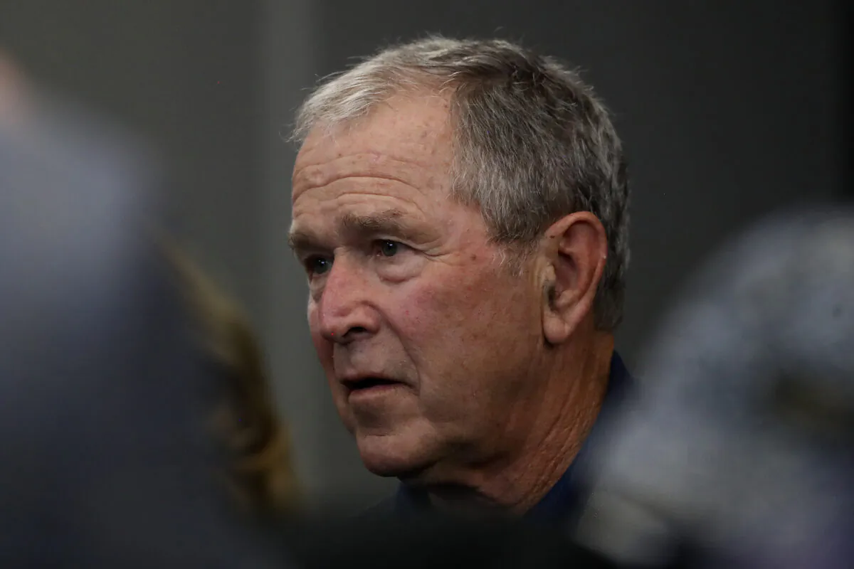 Former President George W. Bush watches the NFL game between the Dallas Cowboys and the Green Bay Packers at AT&T Stadium in Arlington, Texas, on Oct. 6, 2019. (Ronald Martinez/Getty Images)