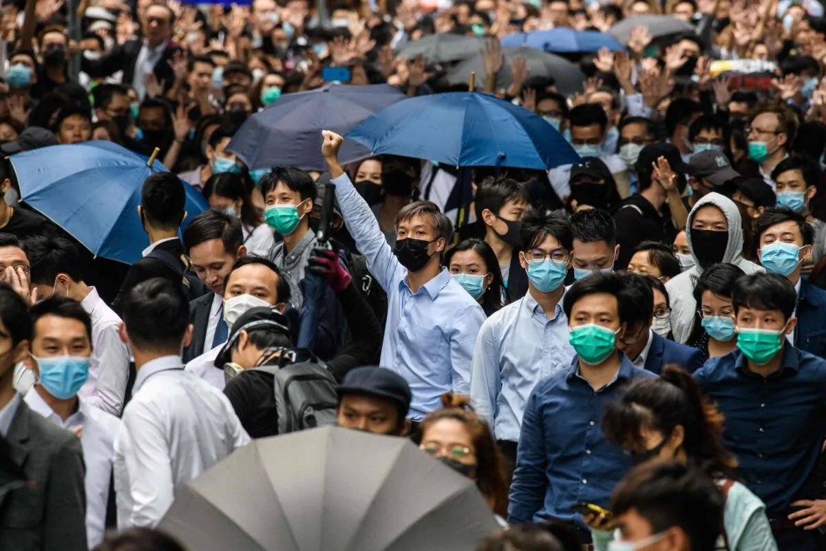 Office workers and pro-democracy protesters gather during a demonstration in Central in Hong Kong on Nov. 12, 2019. (Anthony Wallace/AFP via Getty Images)
