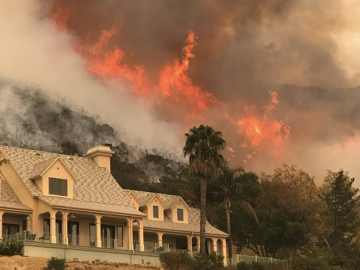 The Santa Barbara County Fire Department shows flames from a back firing operation underway rise behind a home off Ladera Ln near Bella Vista Drive in Santa Barbara, Calif., on Dec. 14, 2017. (Mike Eliason/Santa Barbara County Fire Department via AP Photo)