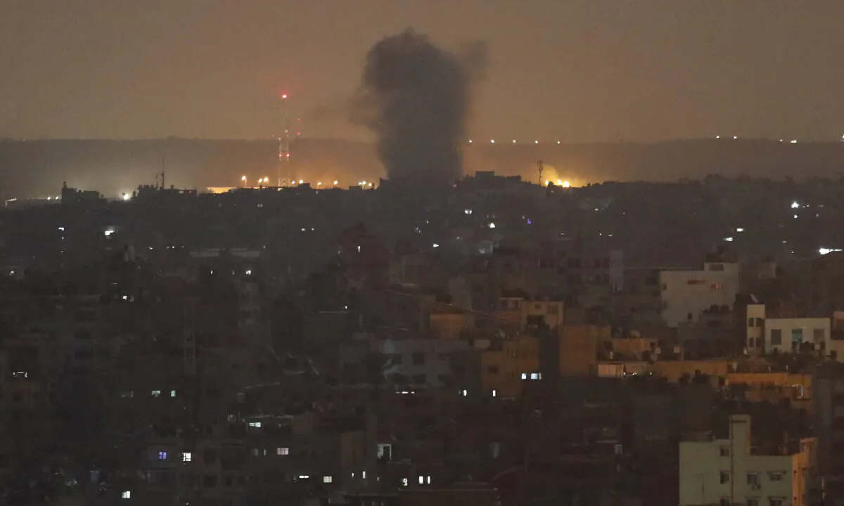 An explosion caused by Israeli airstrikes is seen in Gaza City, early Nov. 14, 2019. (AP Photo/Adel Hana)